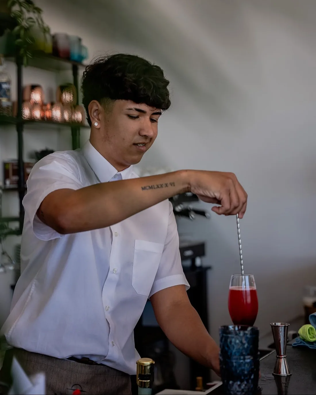 Bartender mixing a cocktail at Navaya